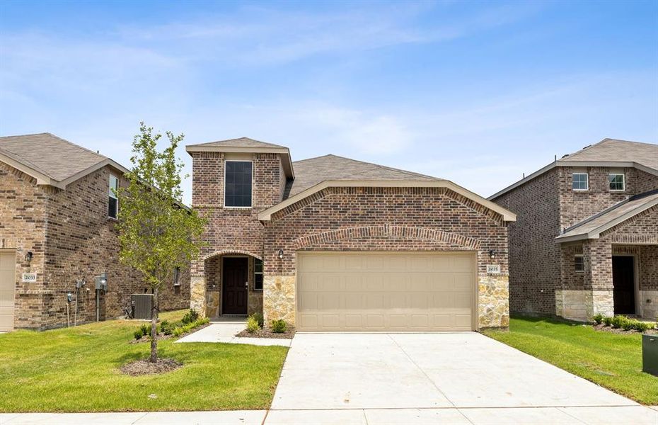 NEW CONSTRUCTION: Beautiful two-story home available at Travis Ranch in Forney *real home pictured