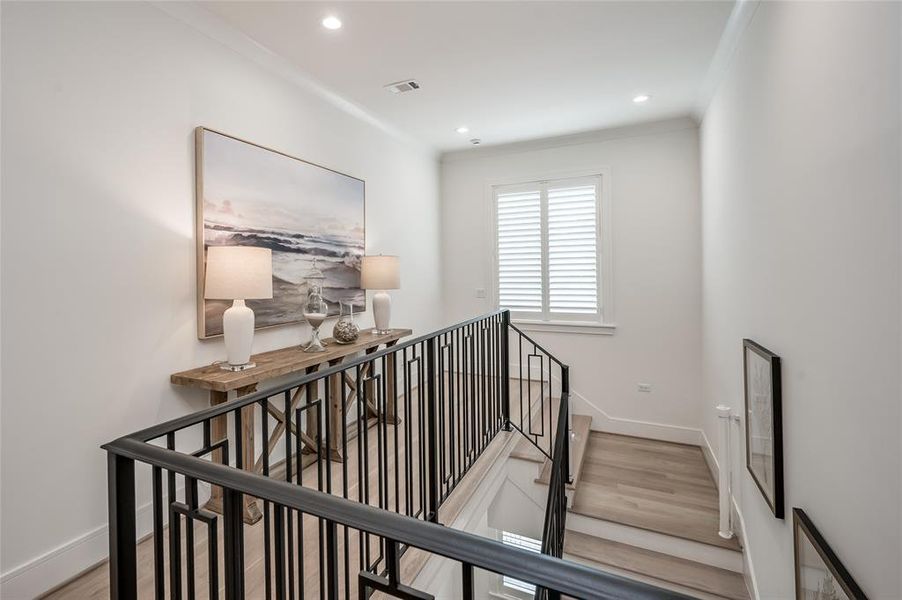 The third floor hallway leads to another secondary suite and bonus/exercise room.