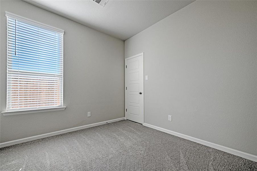 Carpeted empty room with a healthy amount of sunlight