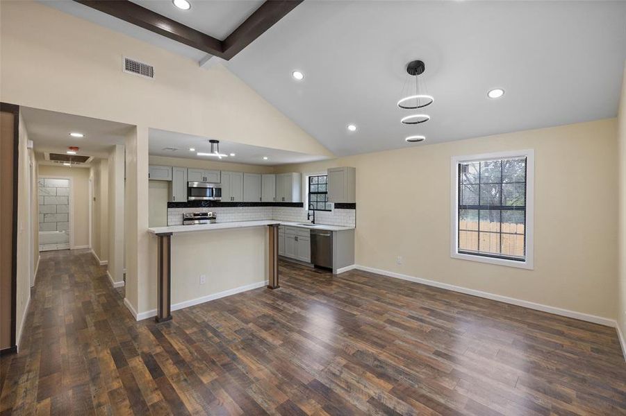 Kitchen featuring dark hardwood / wood-style flooring, appliances with stainless steel finishes, and gray cabinetry