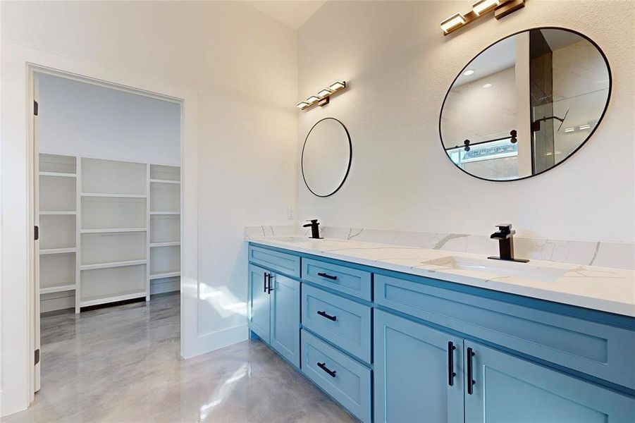 Bathroom featuring concrete flooring and double sink vanity