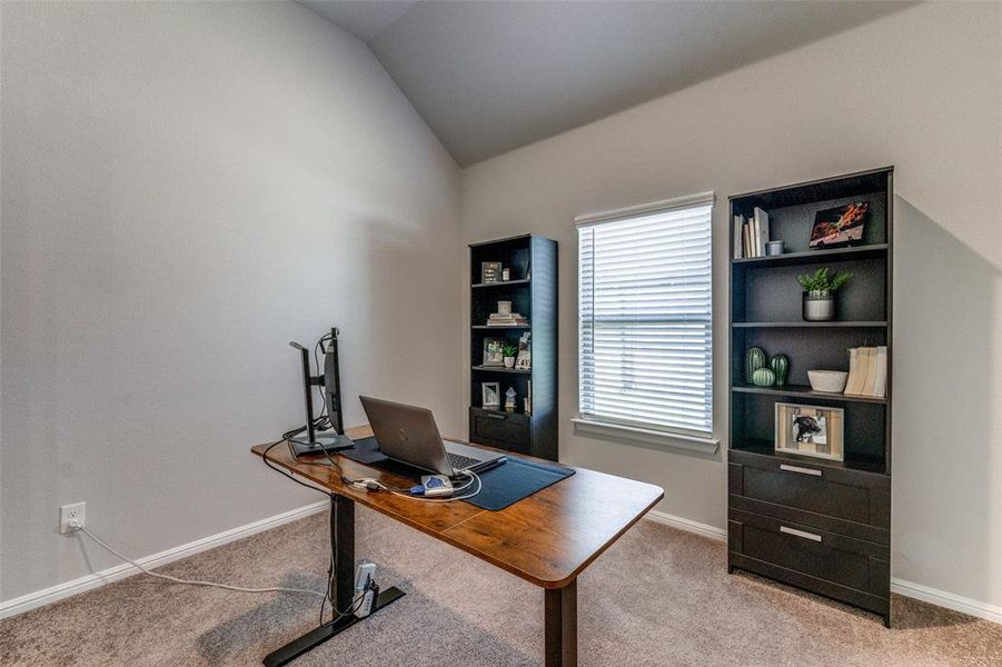 Carpeted home office with 11' sloped ceiling