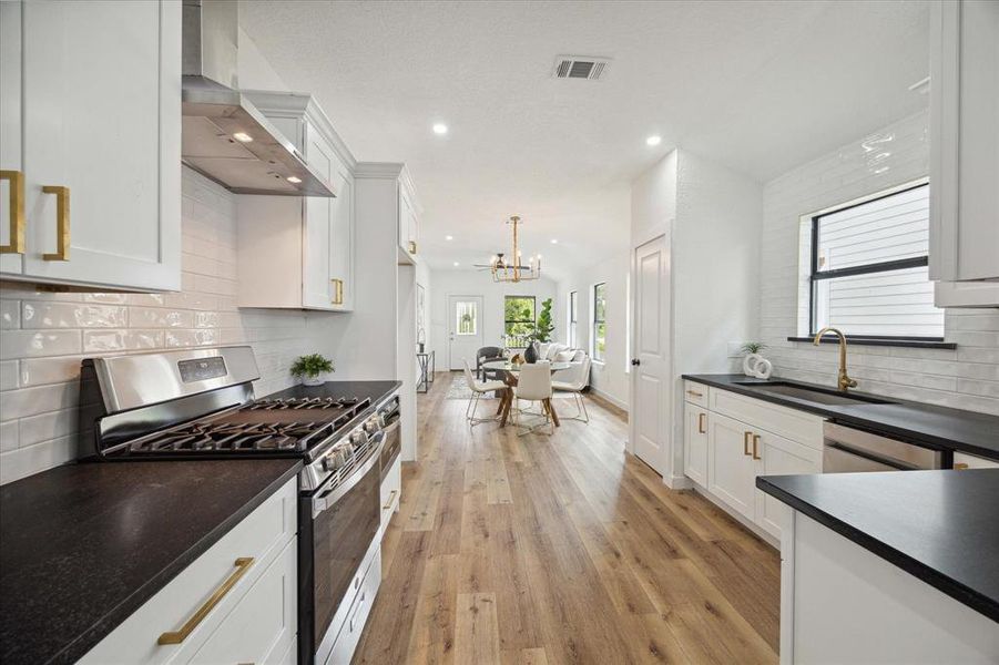 Ditch the takeout and cook from home more often. This fully loaded kitchen offers gorgeous honed granite countertops, subway tile backsplash, sleek stainless steel appliances, crisp white cabinetry with modern pulls and hardware, a deep basin sink, and a large pantry.
