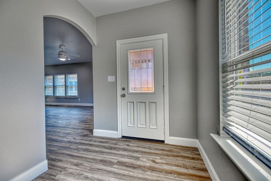 Foyer with ceiling fan and wood-type flooring