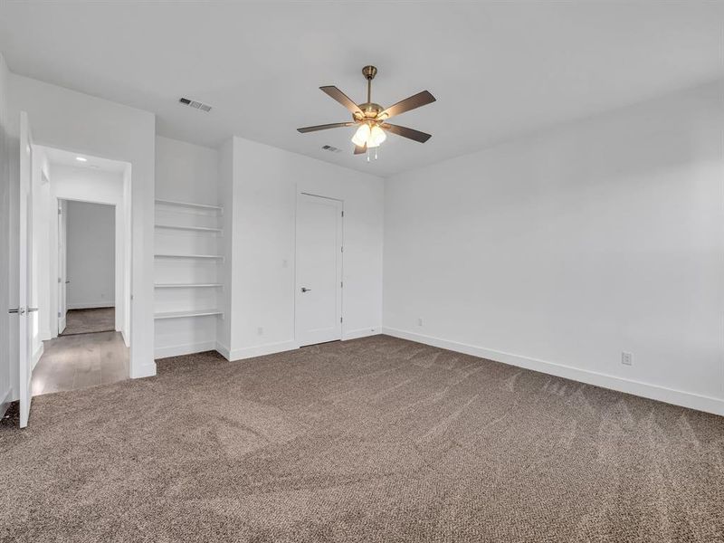 Unfurnished bedroom featuring carpet flooring and ceiling fan