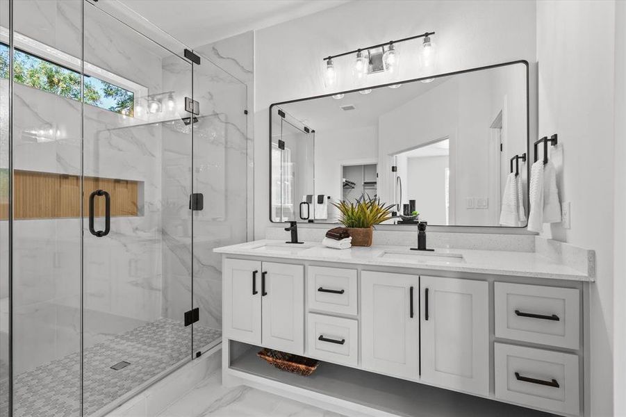 Bathroom featuring vanity and a shower with shower door