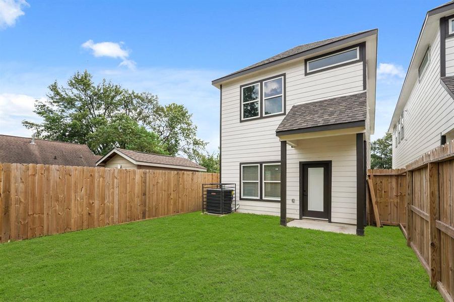 Plenty of room in this fenced back yard to run and play.