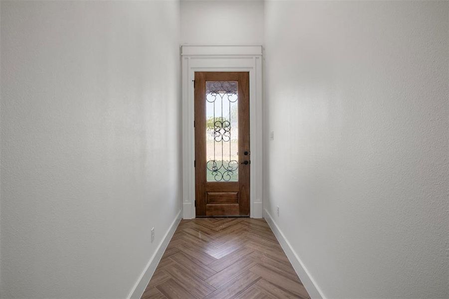 Entryway with light parquet flooring