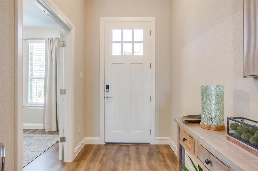 Foyer with a wealth of natural light and light hardwood / wood-style floors