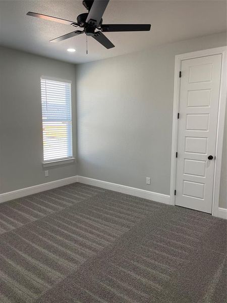 Carpeted 3rd bedroom with ceiling fan