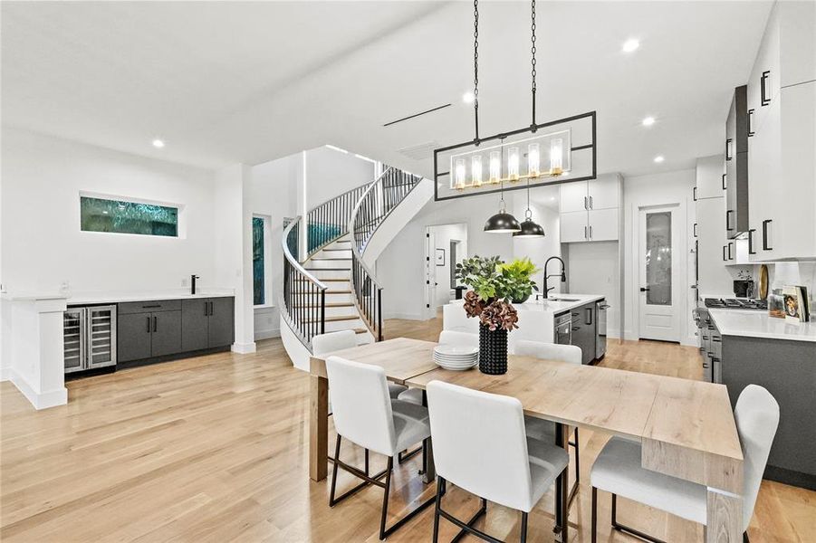 Dining area featuring wine cooler, sink, and light hardwood / wood-style flooring