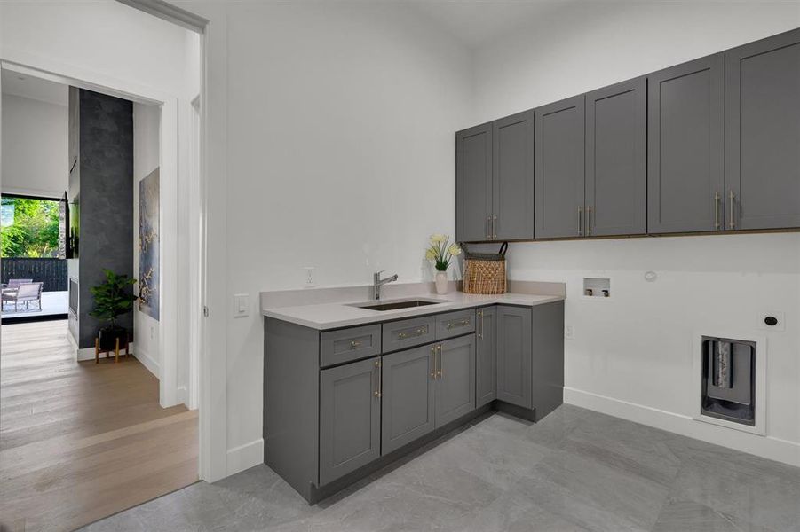 Laundry room with cabinets, hookup for an electric dryer, sink, light hardwood / wood-style flooring, and hookup for a washing machine