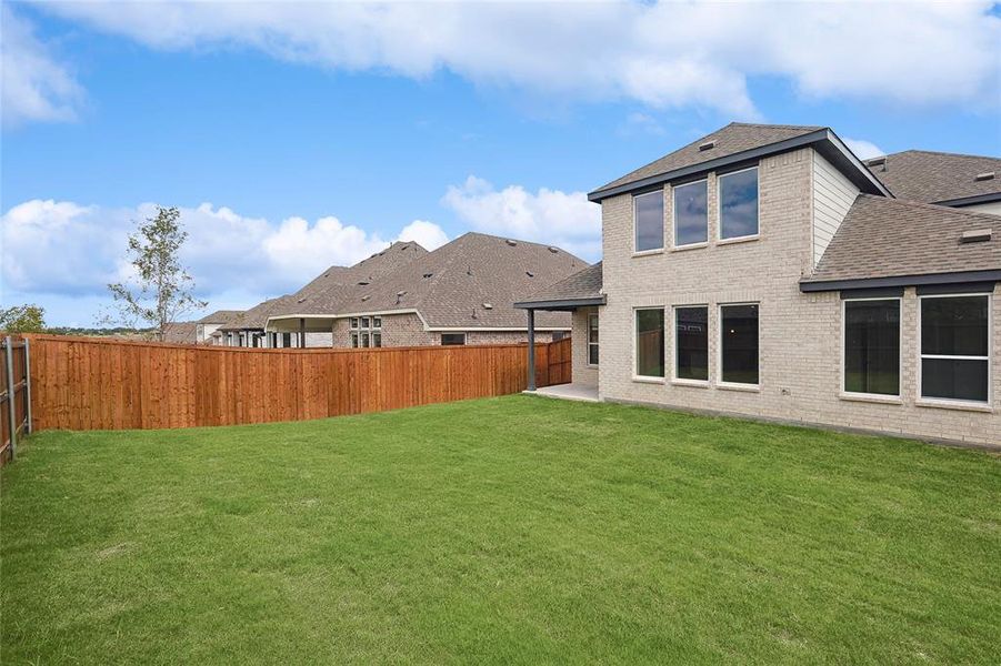 Rear view of house with a yard