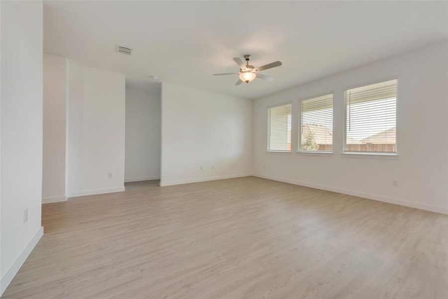 Spare room featuring ceiling fan and light hardwood / wood-style flooring