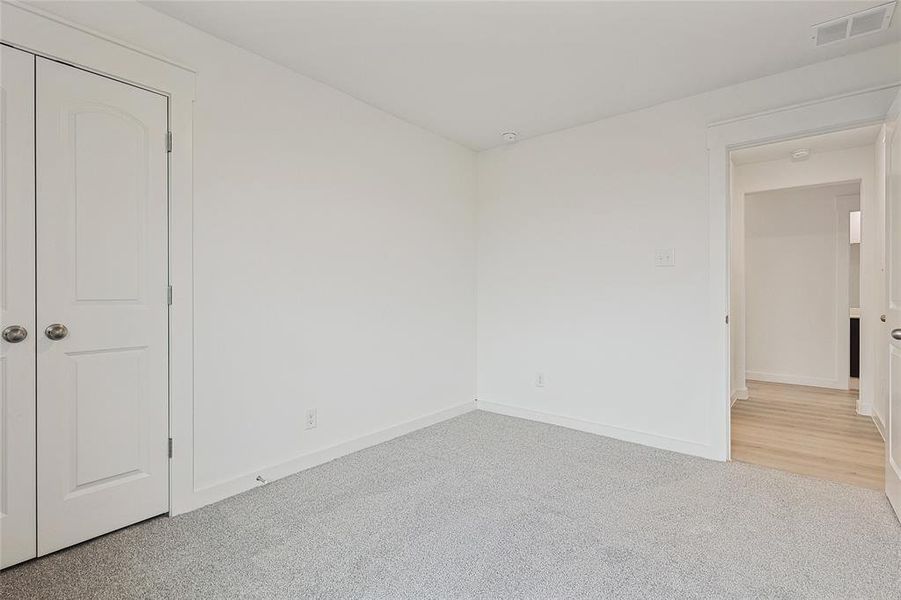 Unfurnished room with carpet