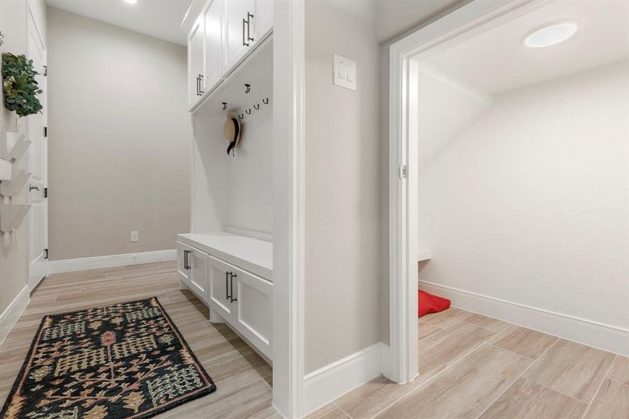 Looking back towards the mud room.... what is this?! Do I see a hidden space under the stairs?