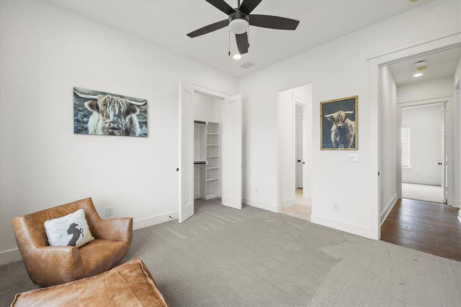 Sitting room with ceiling fan and carpet floors