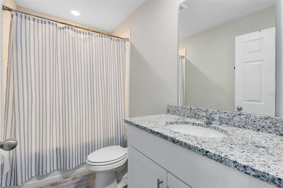 Bathroom 3-located on first floor features tub/shower combination, granite top vanity.