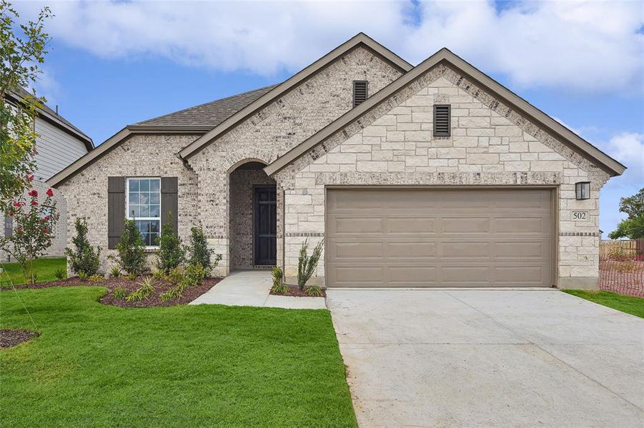 French country inspired facade with a garage and a front lawn