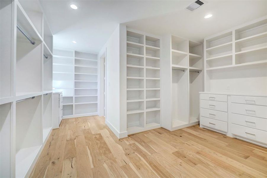 SAMPLE - One of two large primary walk-in closets. This one opens to adjacent laundry room.