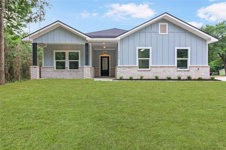 Home has a board and batten exterior with brick surround, a 30 year roof, and side garage for curb appeal