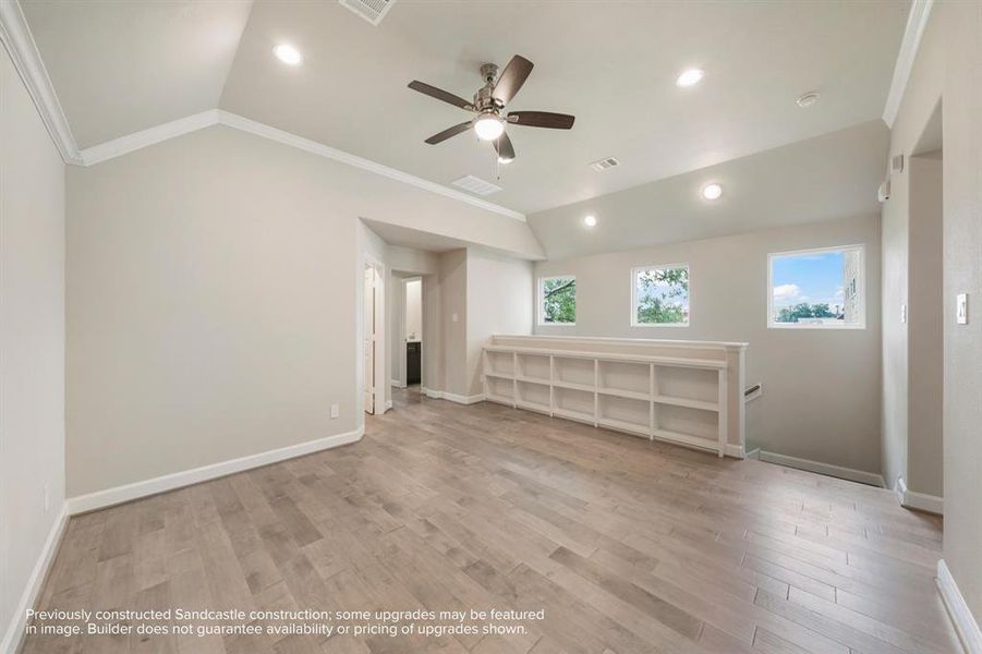 Entertainer's Nook: This game room is perfectly appointed with built-in shelves to showcase your interests and a ceiling fan above to ensure a cool, inviting atmosphere for every play.