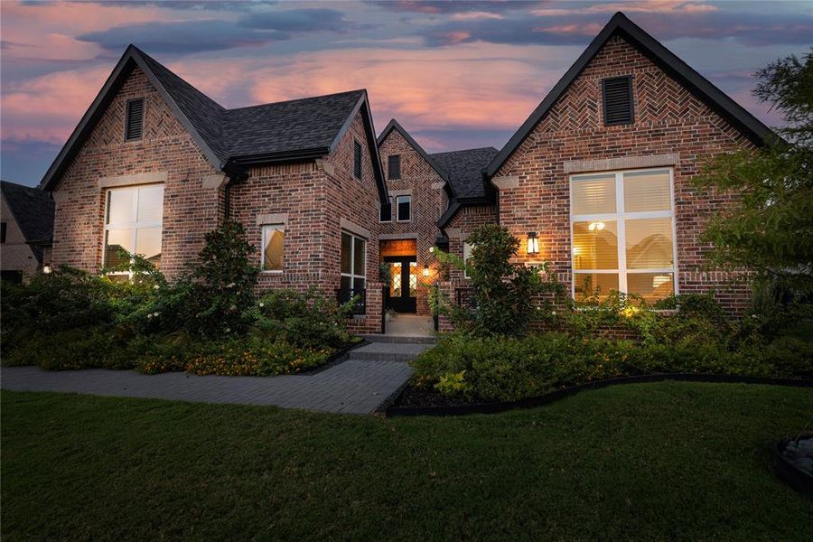 English style home featuring a patio and a yard