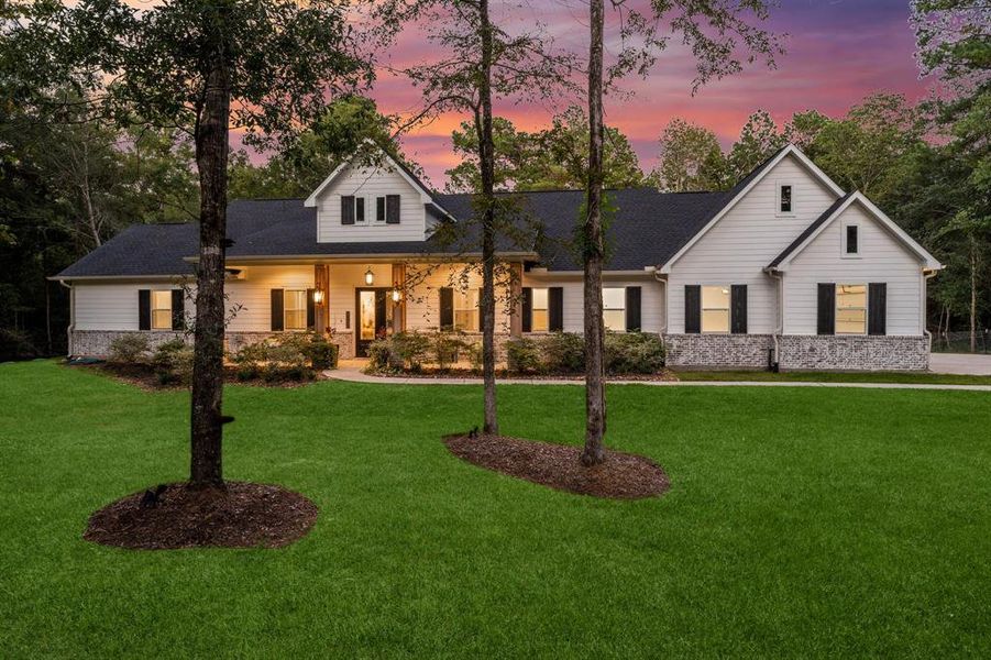 A regal setting, this one-story home greets you and your guests with charm and the welcoming 36' long front porch!