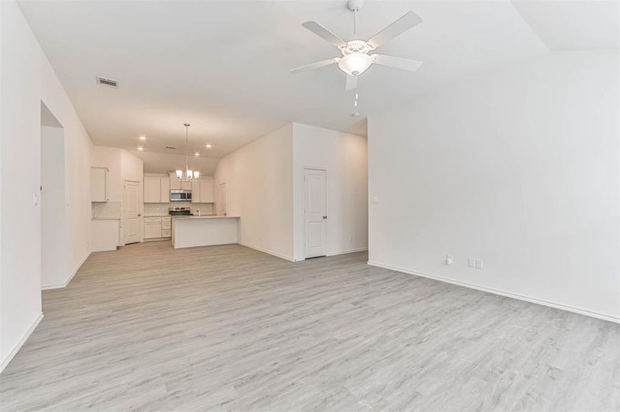 The open floor plan allows for a seamless flow between the living room, dining area, and kitchen.