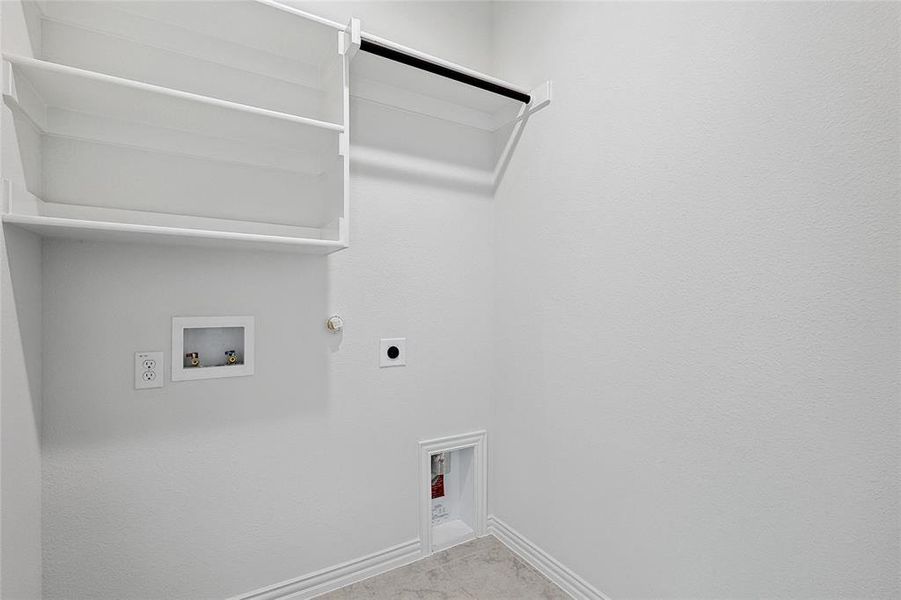 Clothes washing area with hookup for a gas dryer, tile flooring, hookup for a washing machine, and hookup for an electric dryer