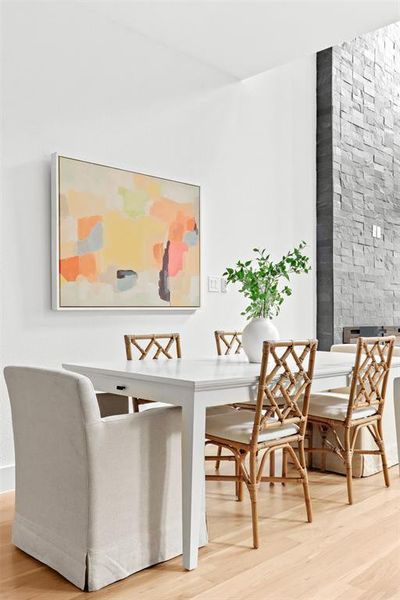 Dining area featuring a fireplace and light wood-type flooring