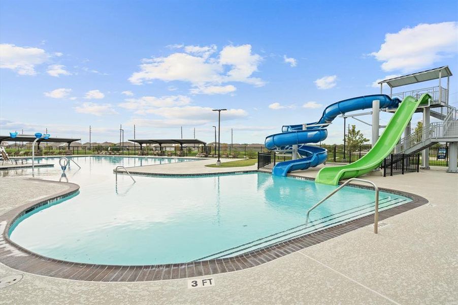 This is the community pool with a fun water slide feature, shaded areas, and ample deck space, offering a great spot for family leisure and entertainment.