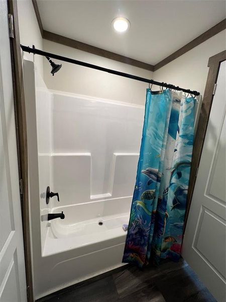 Bathroom featuring shower / tub combo with curtain