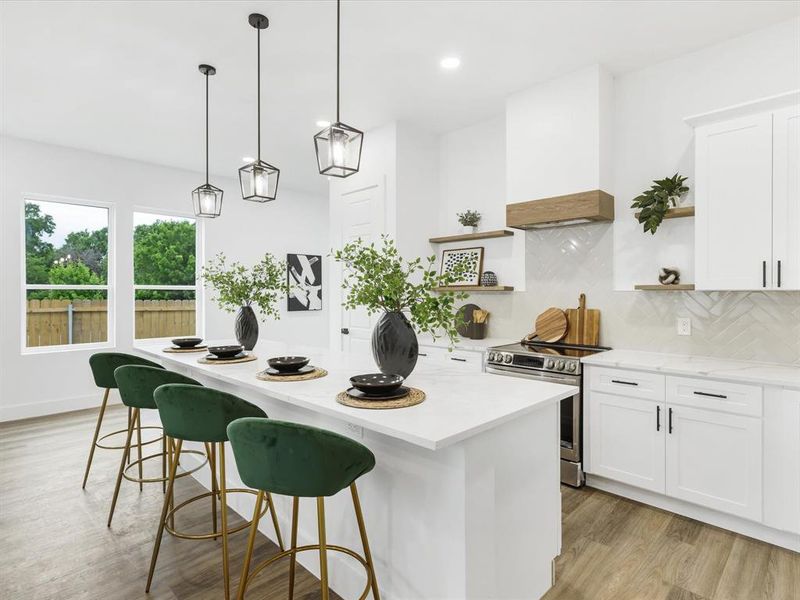 Kitchen featuring white cabinets, backsplash, light hardwood / wood-style floors, stainless steel range with electric cooktop, and custom exhaust hood
