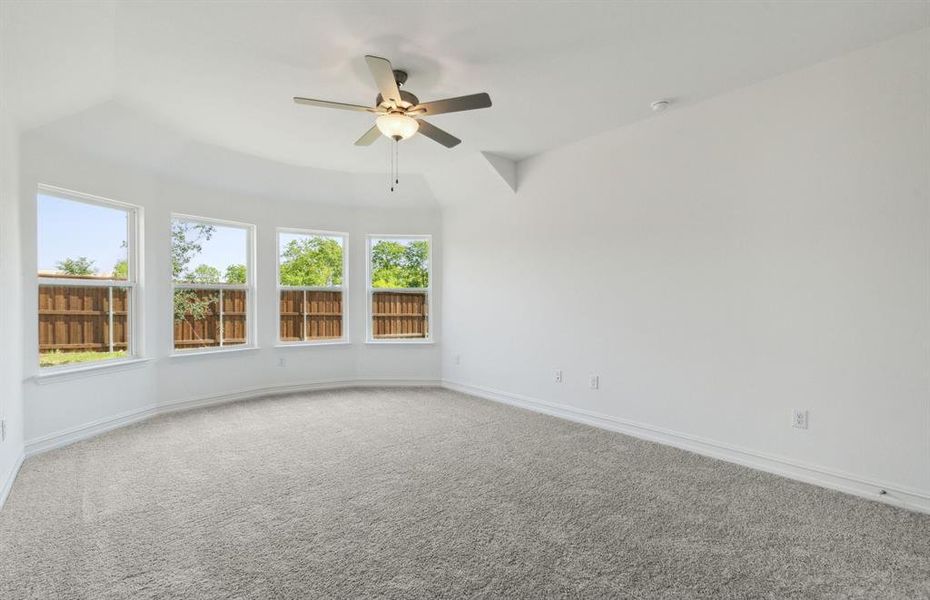 Elegant owner's suite with bay window *real home pictured