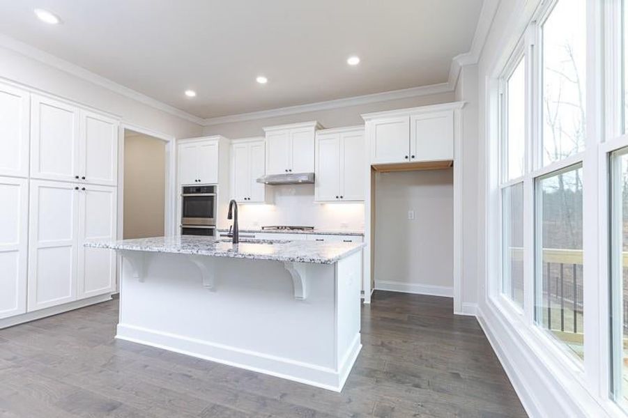 This kitchen is a chef's dream with large island and lots of cabinets.  Photo not actual home, but previously built Mansfield plan.