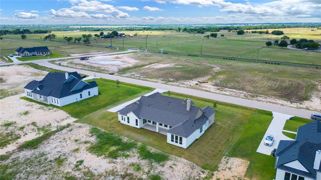 Birds eye view of property with a rural view