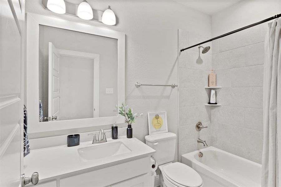 Full bathroom featuring shower / bath combo, vanity, and toilet