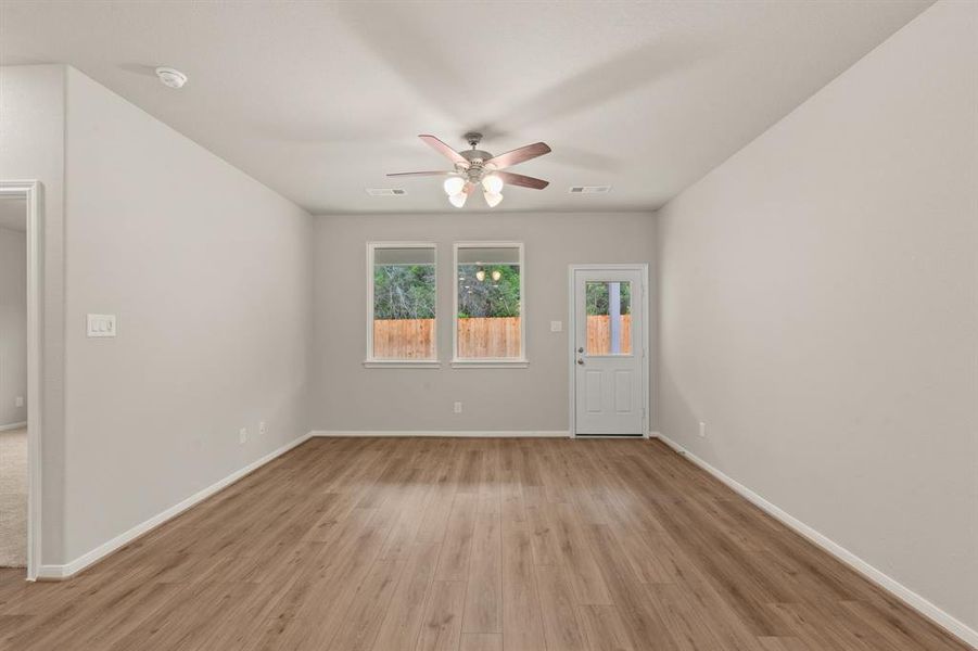 Your family room has ample space to entertain family and friends. This space features beautiful floors, fresh paint, ceiling fan with lighting, and high ceilings.