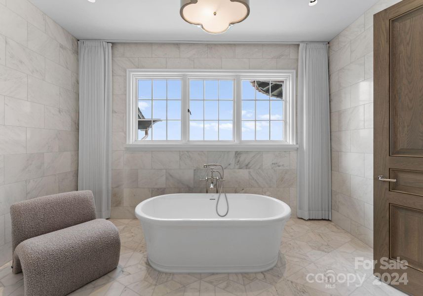 Upper-level secondary En-suite features two vanities, a soaker tub, and a separate shower room.