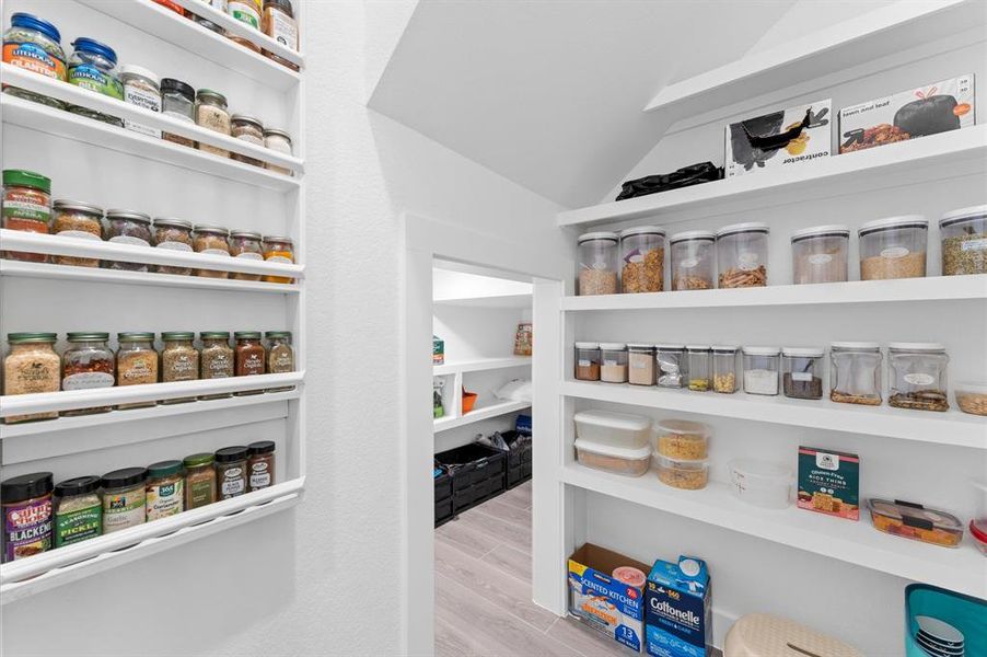 The walk-in pantry provides ample storage space, designed to keep your kitchen organized and clutter-free.