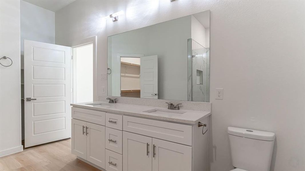 Primary bath with dual sinks and built in cabinets