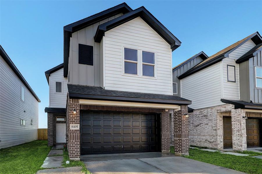 Altermate view of the home's front elevation. Two-tone hardie siding is complimented by traditional brick.