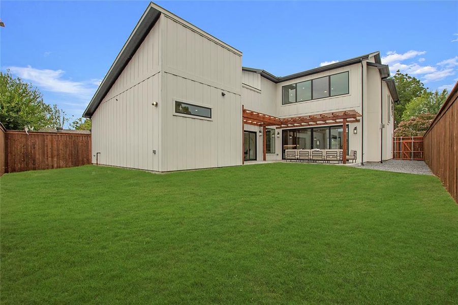 Back of house with a patio area and a yard