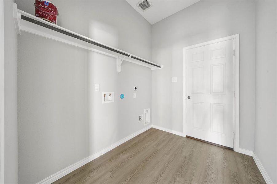 Laundry/utility room leading toward attached garage