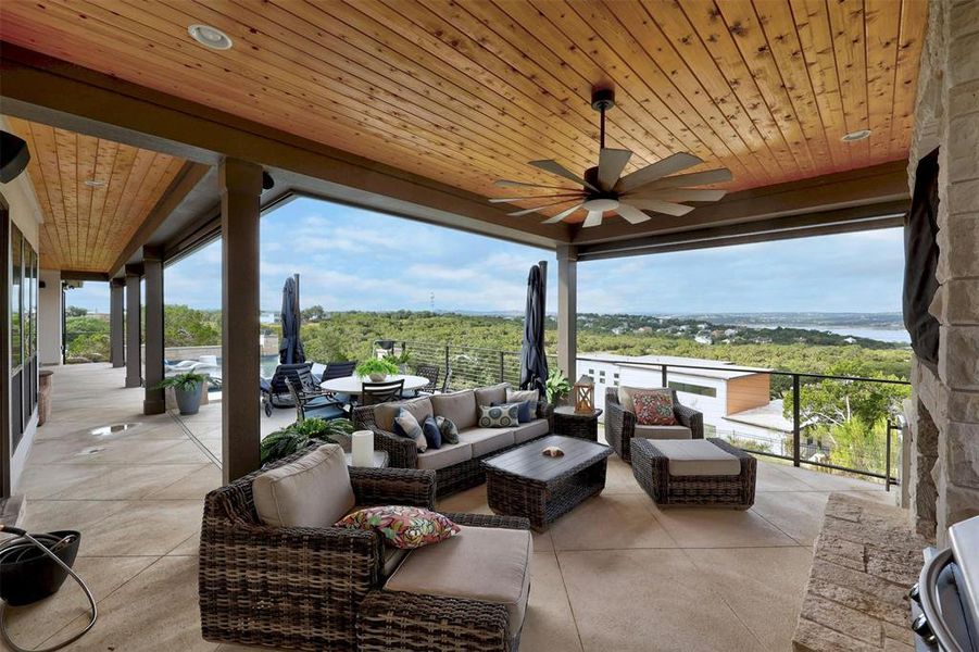 Gorgeous outdoor living room with gas fireplace and area for TV above.