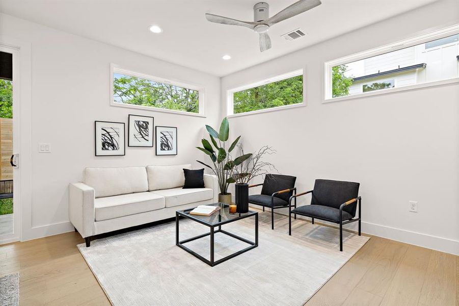 Living room windows let in a ton of natural light but are artfully placed to provide privacy from the front unit.