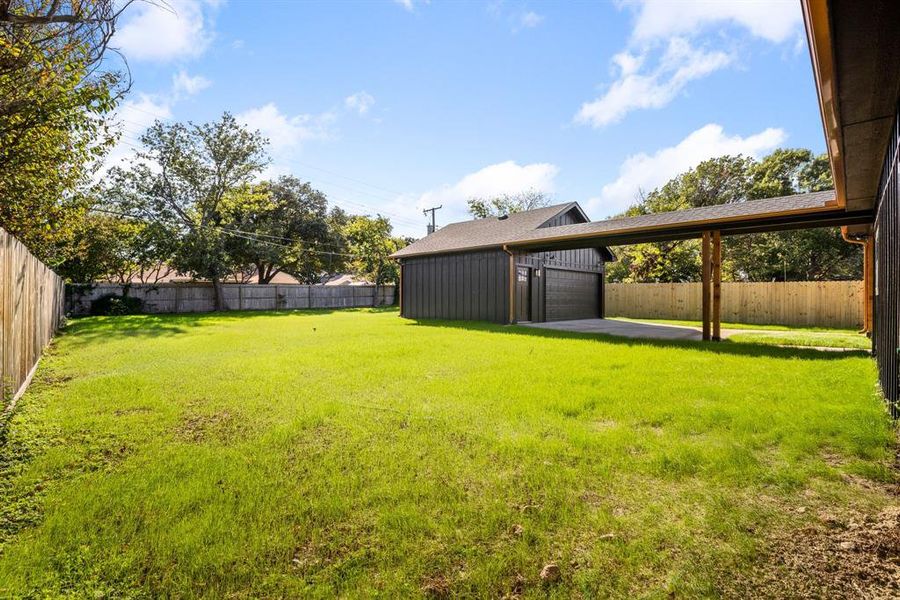 View of yard with an outbuilding and a garage