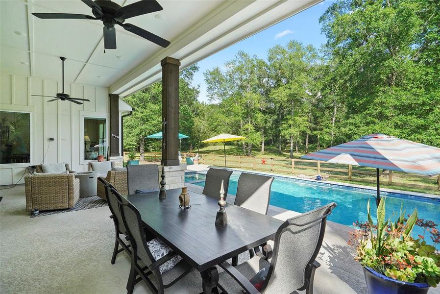 Enjoy summer BBQs and back yard birthday parties with this charming covered poolside patio with cooling fans and plenty of room for a grill and seating for friends and family.