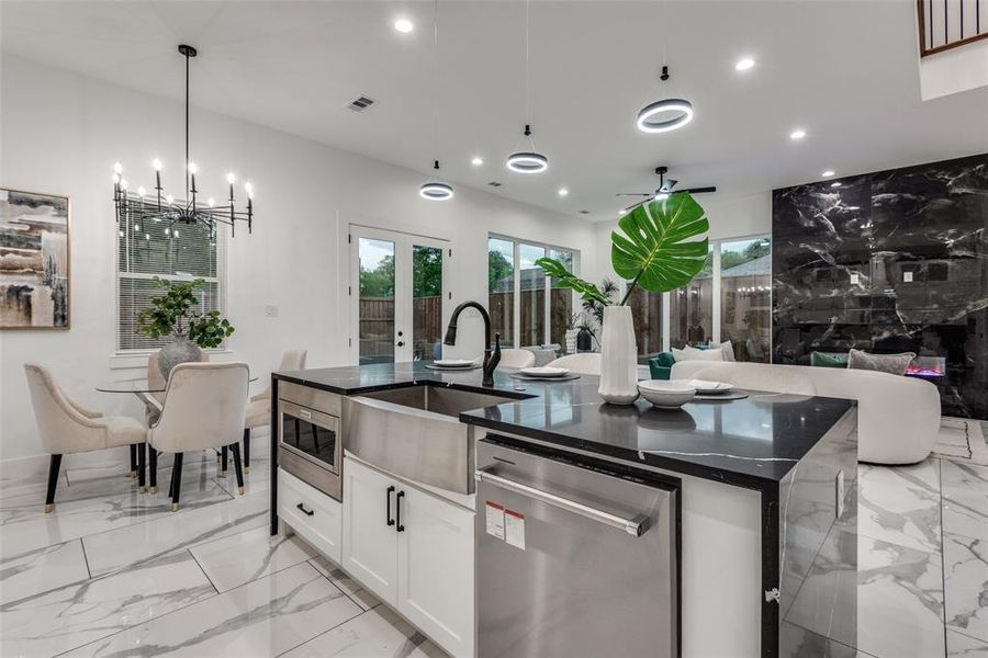 Kitchen island featuring stainless steel appliances and farmhouse sink.